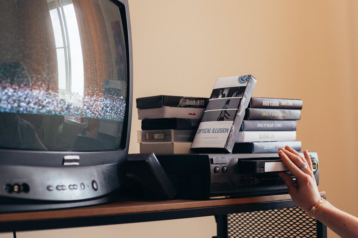 Person relaxing on couch watching Channel Surfer YouTube TV guide in a nostalgic living room setting